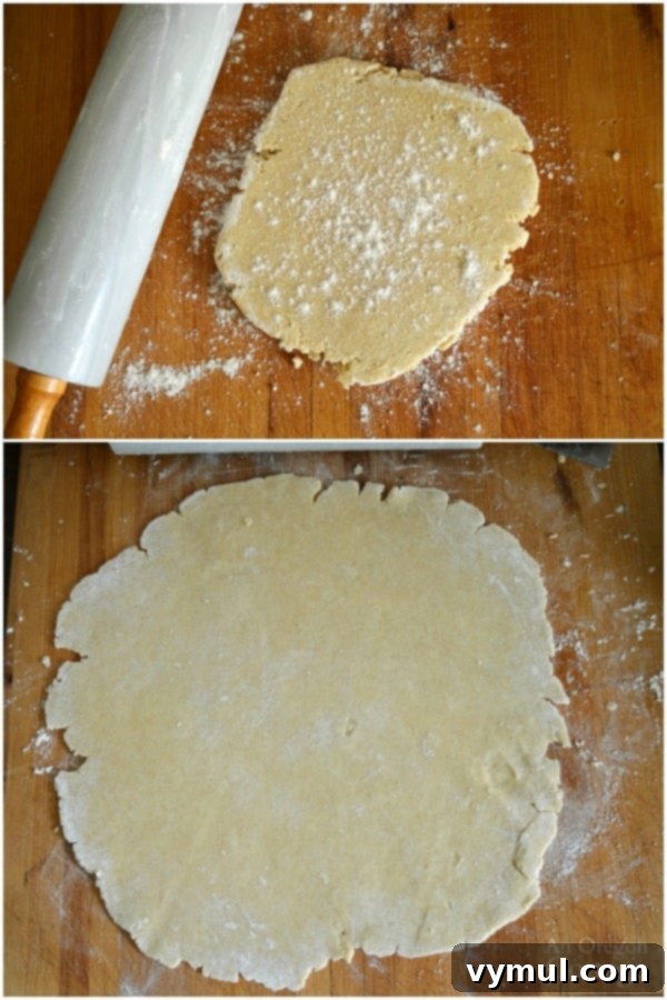 Rolling out the best homemade pie crust, showing visible butter pieces for flakiness.
