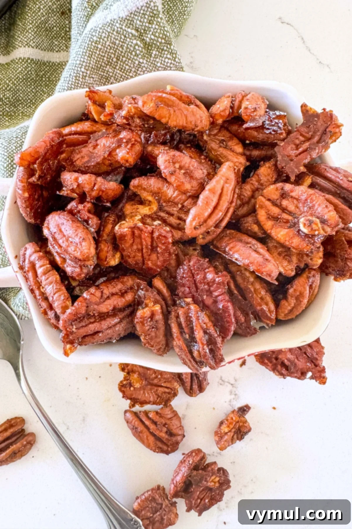 maple candied pecans in white bowl, a delicious and healthy snack