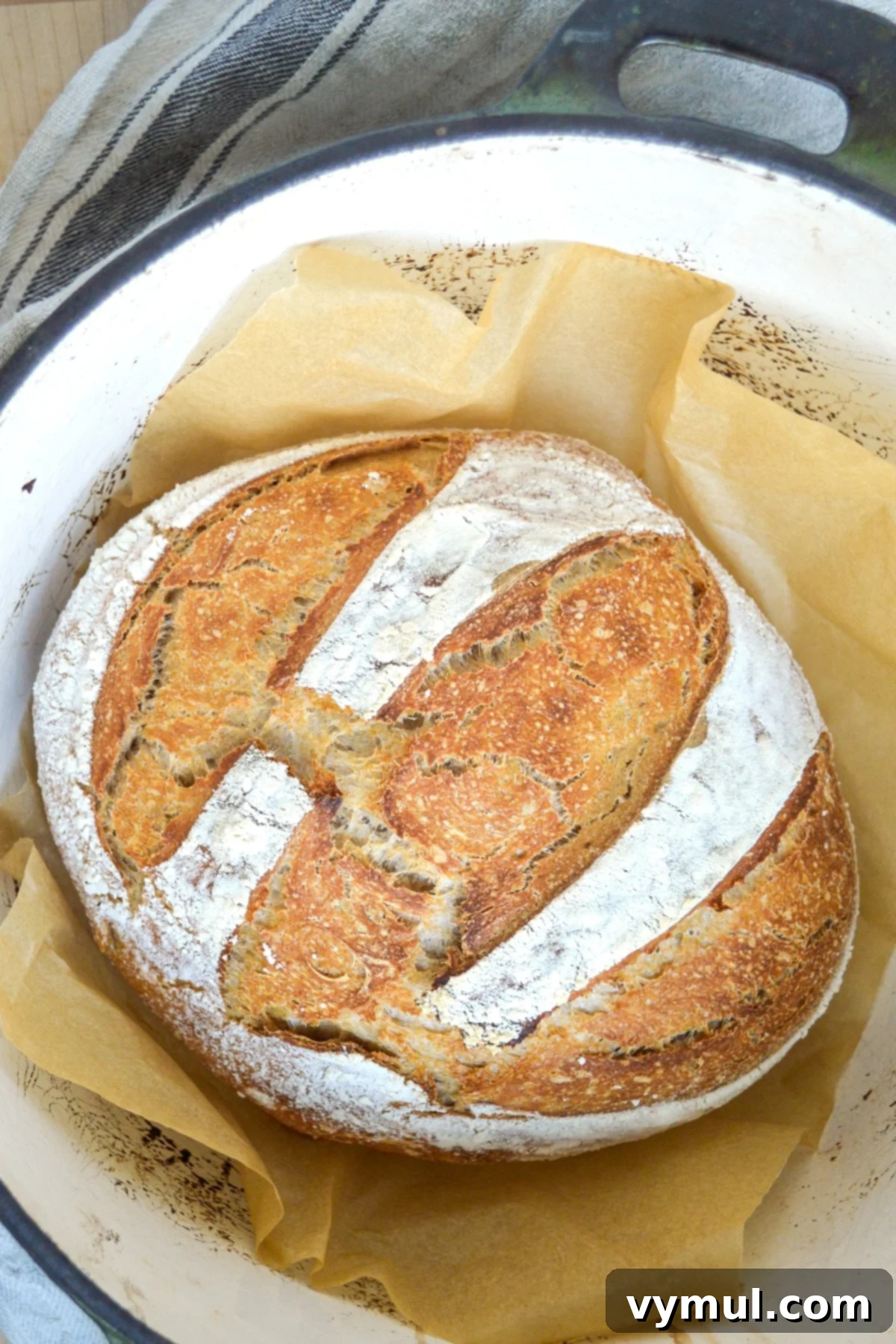The One-Day Sourdough Secret: Artisan Bread Made Simple 14 baked sourdough artisan bread, golden brown and crusty, fresh out of the pot from the oven