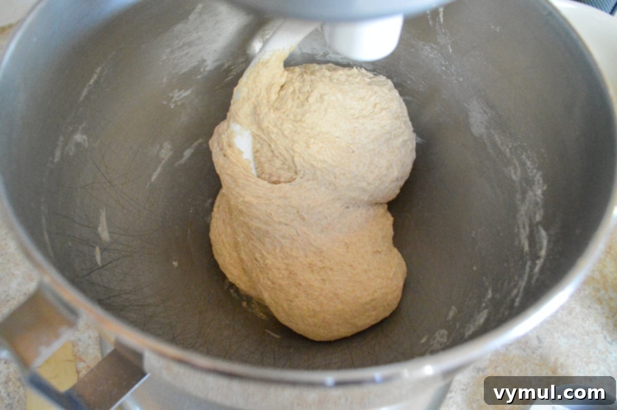 The One-Day Sourdough Secret: Artisan Bread Made Simple 4 mixing sourdough artisan bread dough in a KitchenAid stand mixer with a dough hook