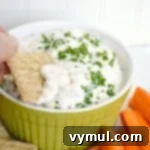 Creamy feta dip served on a cracker, highlighting its smooth texture