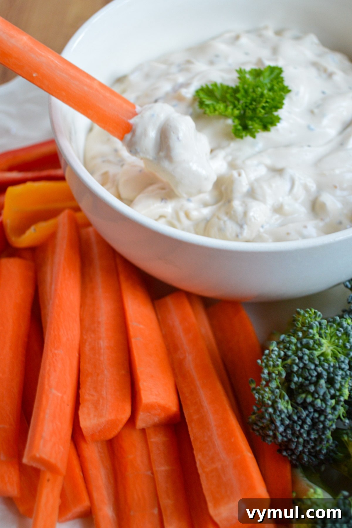 Best Ever Easy Homemade French Onion Dip 5 scooping onion dip with carrot stick