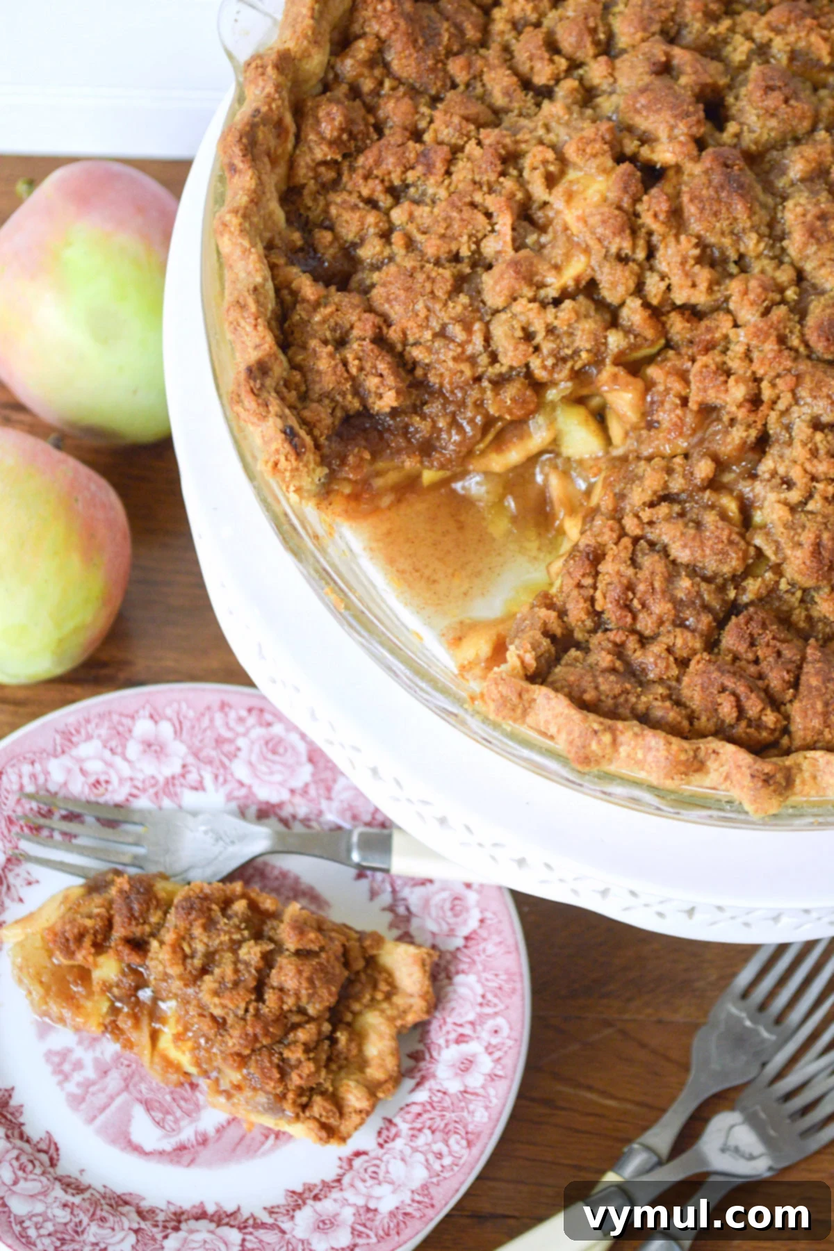 baked apple pie with one piece removed on a plate