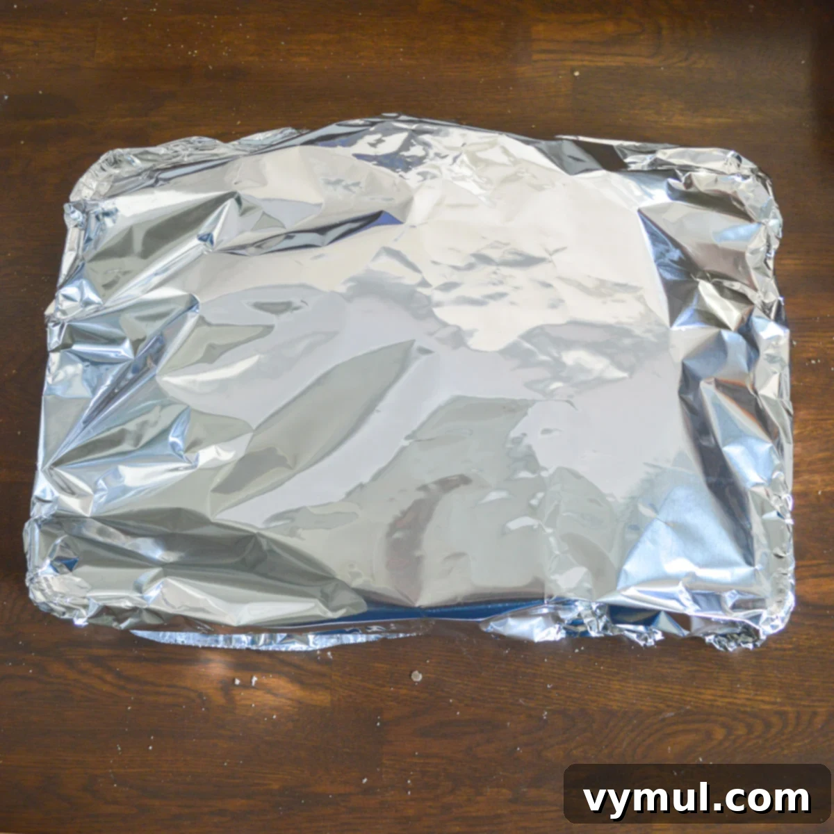 foil covered pie and cookie sheet ready for oven