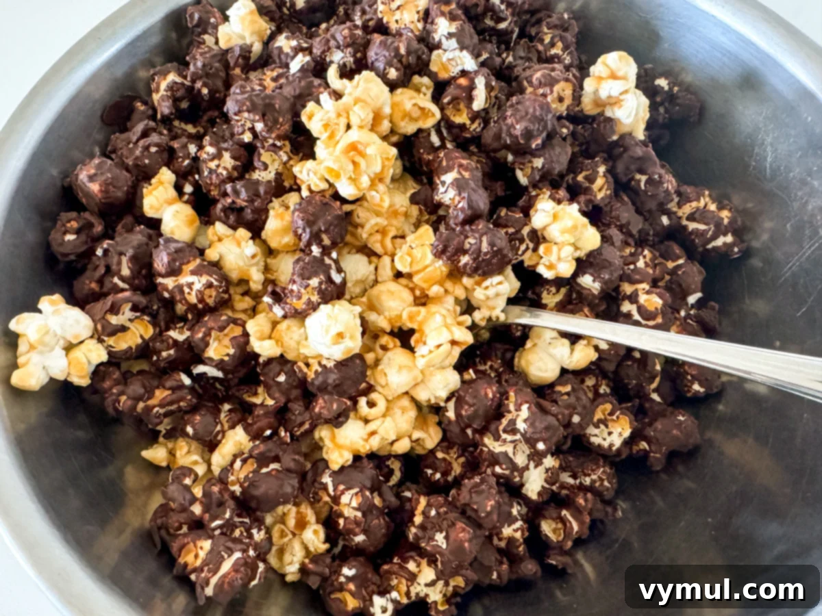 Foolproof Moose Munch Caramel Corn No Corn Syrup No Thermometer 13 Mixing plain caramel corn with hardened chocolate-coated caramel corn in a large bowl to create homemade Moose Munch.