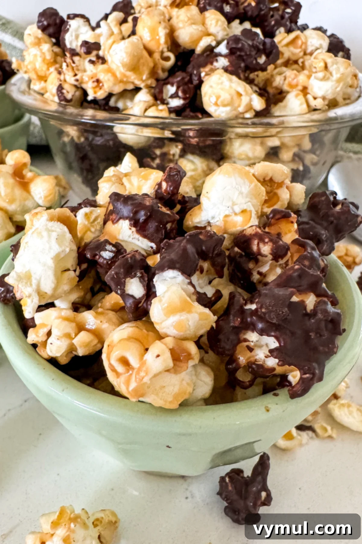 Foolproof Moose Munch Caramel Corn No Corn Syrup No Thermometer 14 A vibrant green bowl filled with delicious homemade Moose Munch popcorn, showcasing the mix of chocolate-coated and plain caramel corn.