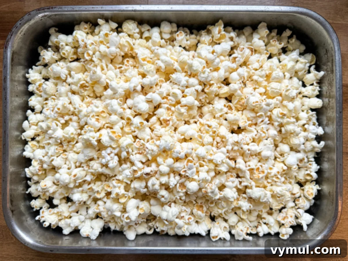 Foolproof Moose Munch Caramel Corn No Corn Syrup No Thermometer 4 Freshly popped popcorn ready in a large roasting pan, preparing for the caramel coating.