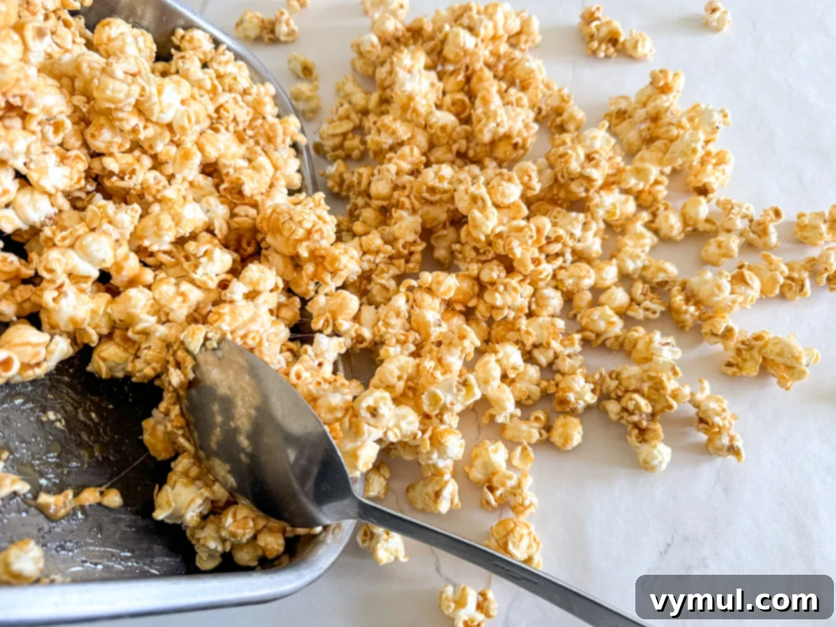 Foolproof Moose Munch Caramel Corn No Corn Syrup No Thermometer 9 Hot caramel corn being scooped onto waxed paper to cool and break apart.