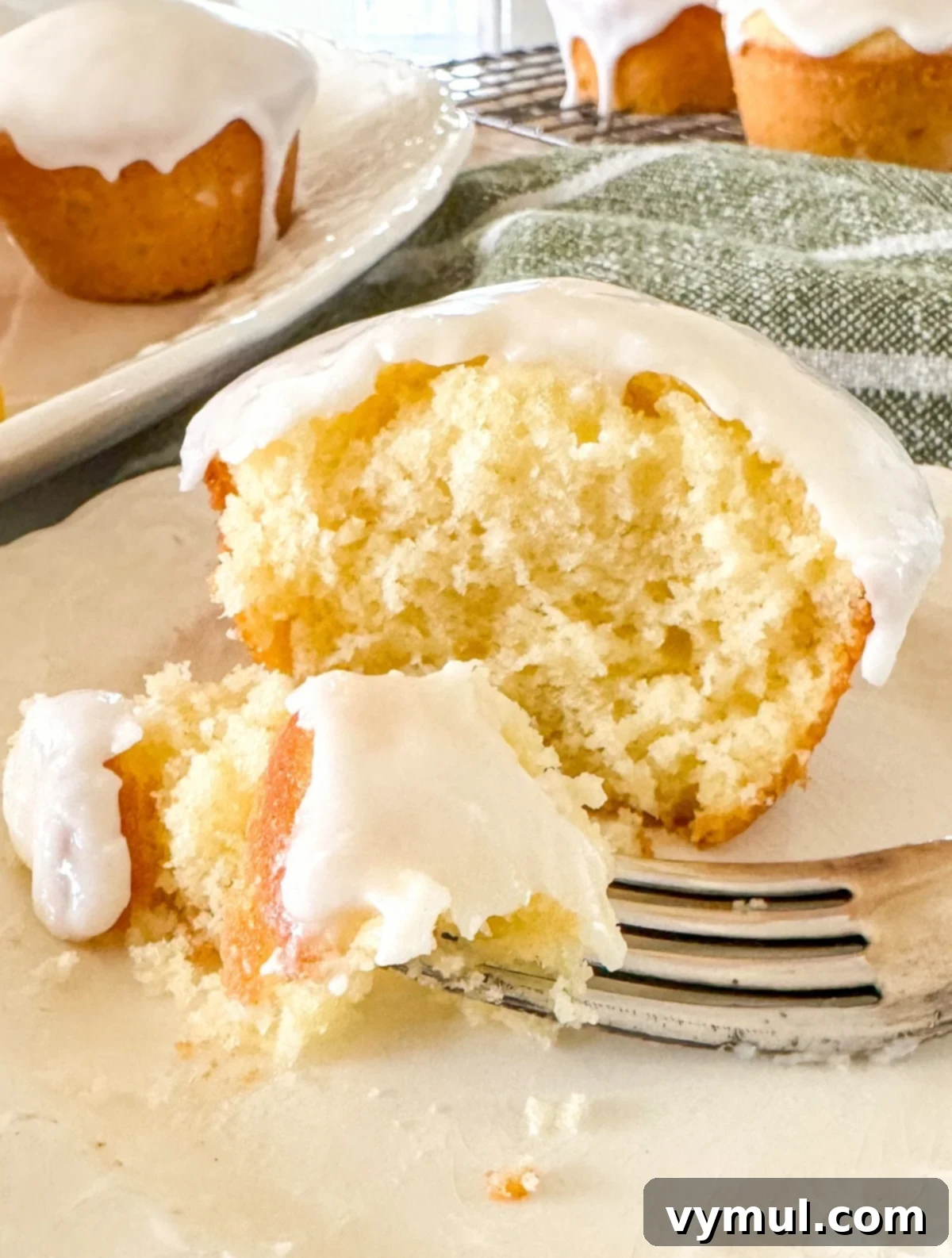 Luscious Lemon Cupcakes with a Sweet Glaze Drizzle 9 eating lemon cupcake with fork