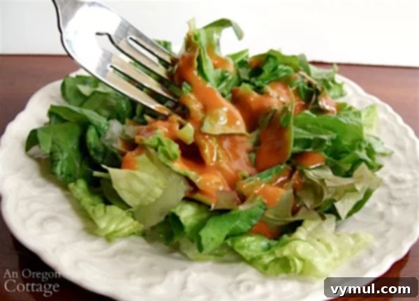 Delicious and healthy American French dressing in a clear glass bottle, ready to pour over a fresh salad.