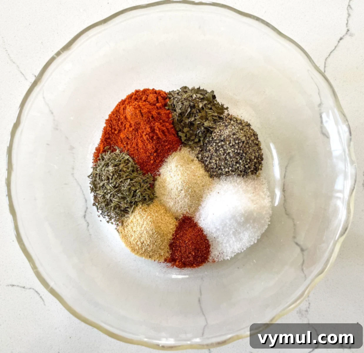 spices in a bowl for rubbing on whole chicken
