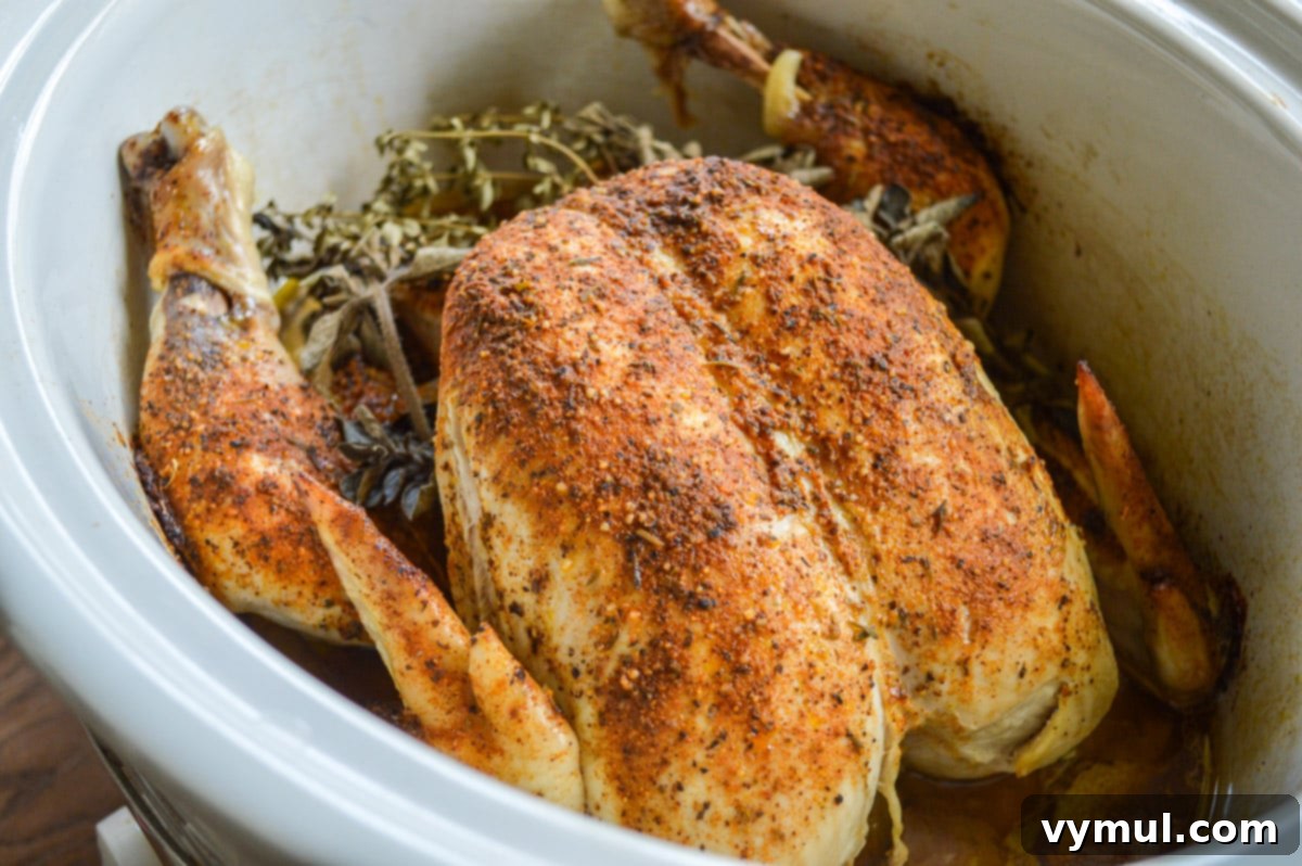 Cooked whole chicken in a slow cooker