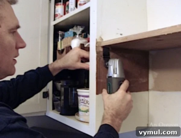 Cutting out cabinet shelf for installing microwave