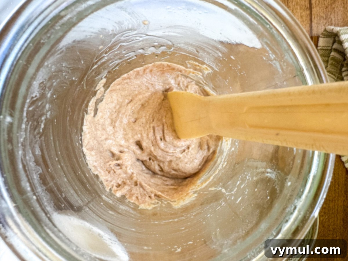 mixing sourdough starter in jar above