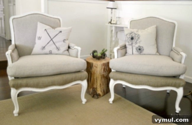 Two newly upholstered French chairs with distressed white frames in a bright room