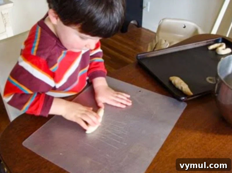 Homemade Soft Pretzels: Quick and Easy in 30 Minutes 9 4-year-old shaping pretzel dough with concentration
