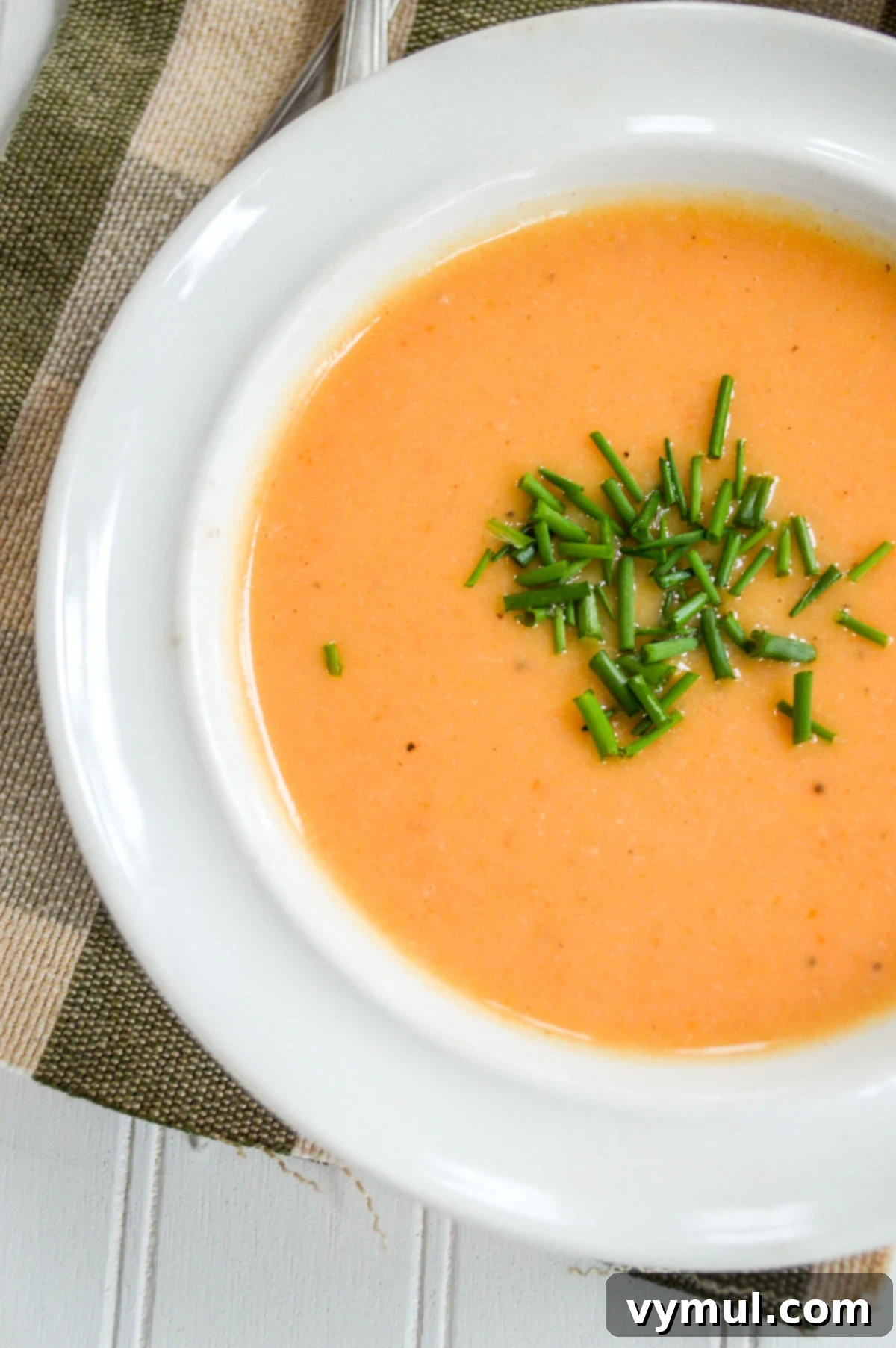 Amazing 30-Minute Cauliflower Cheese Soup 2 A steaming bowl of creamy cauliflower cheese soup, garnished with fresh herbs, ready to be enjoyed.