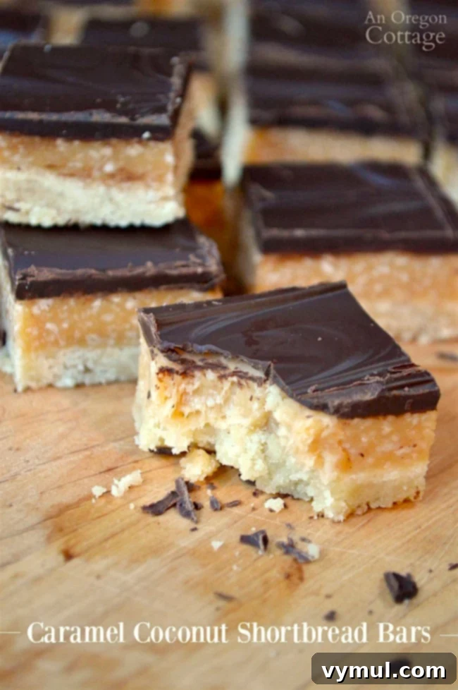 Decadent Caramel Coconut Shortbread Bars 2 Caramel Coconut Shortbread Cookie Bars on cutting board, showcasing layers of shortbread, caramel coconut, and dark chocolate