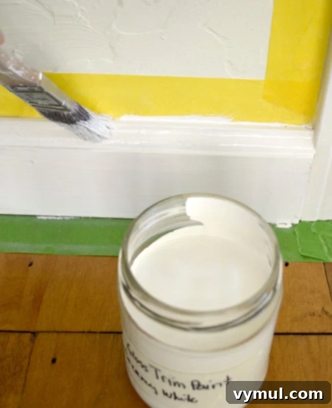 Applying a fresh coat of paint to baseboards with an angled brush