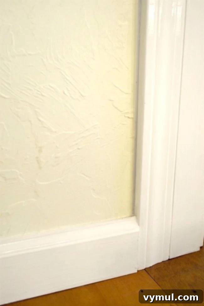 After image of perfectly painted baseboards and trim, showing a refreshed room