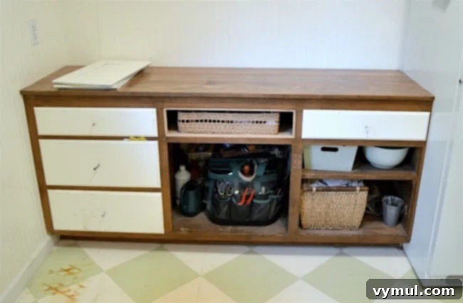 DIY Beadboard Faux Double Door Electrical Panel Cover 10 Mudroom Makeover: Before image of the upcycled cabinet, showing its original size and the tight space it needed to fit into.