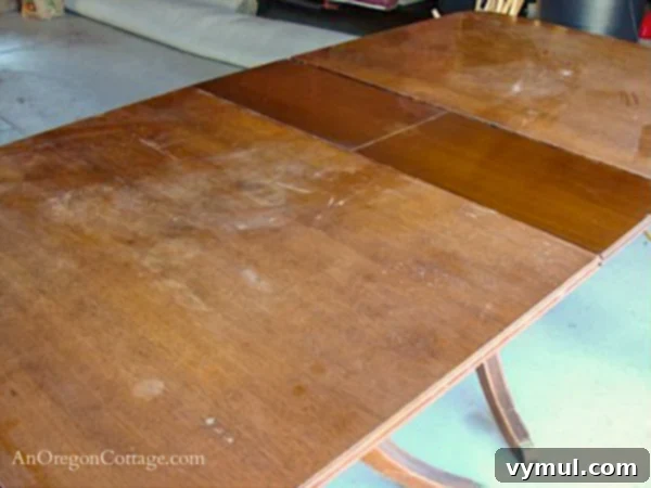 dining table before: An unrefinished, worn dining table with visible scratches and an aged finish, showing its original condition before the makeover.