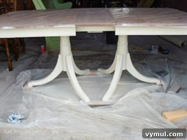 painted dining table base-step3: The dining table base after being painted with a creamy white finish, highlighting its refreshed appearance.