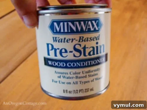 pre-stain can for sanded tabletop-step5: A can of wood pre-stain conditioner, essential for preparing the sanded tabletop for even stain application.
