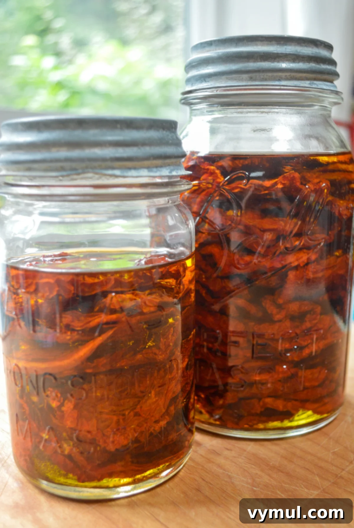jars of dried tomatoes covered in oil