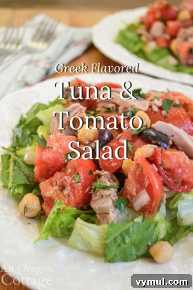 Greek Tuna Tomato Delight 2 Vibrant Greek flavored tuna tomato salad on a white plate, garnished with fresh parsley, ready to be enjoyed.