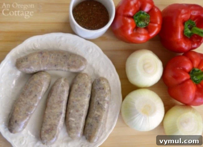 Sheet Pan Sausage & Veggies 3 Fresh ingredients laid out for roasted sausages: sausages, colorful bell peppers, onions, olive oil, and spices
