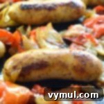 Sheet Pan Sausage & Veggies 8 Close-up of perfectly roasted Italian sausages, caramelized onions, and tender bell peppers on a baking sheet