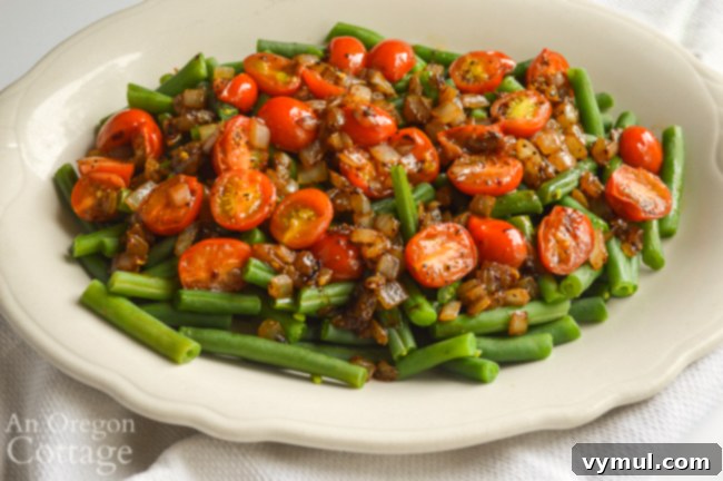 Speedy Healthy Green Bean Delight with Caramelized Onions and Tomatoes 3 Platter of green beans topped with rich caramelized onions and vibrant red tomatoes, showcasing a healthy side dish.