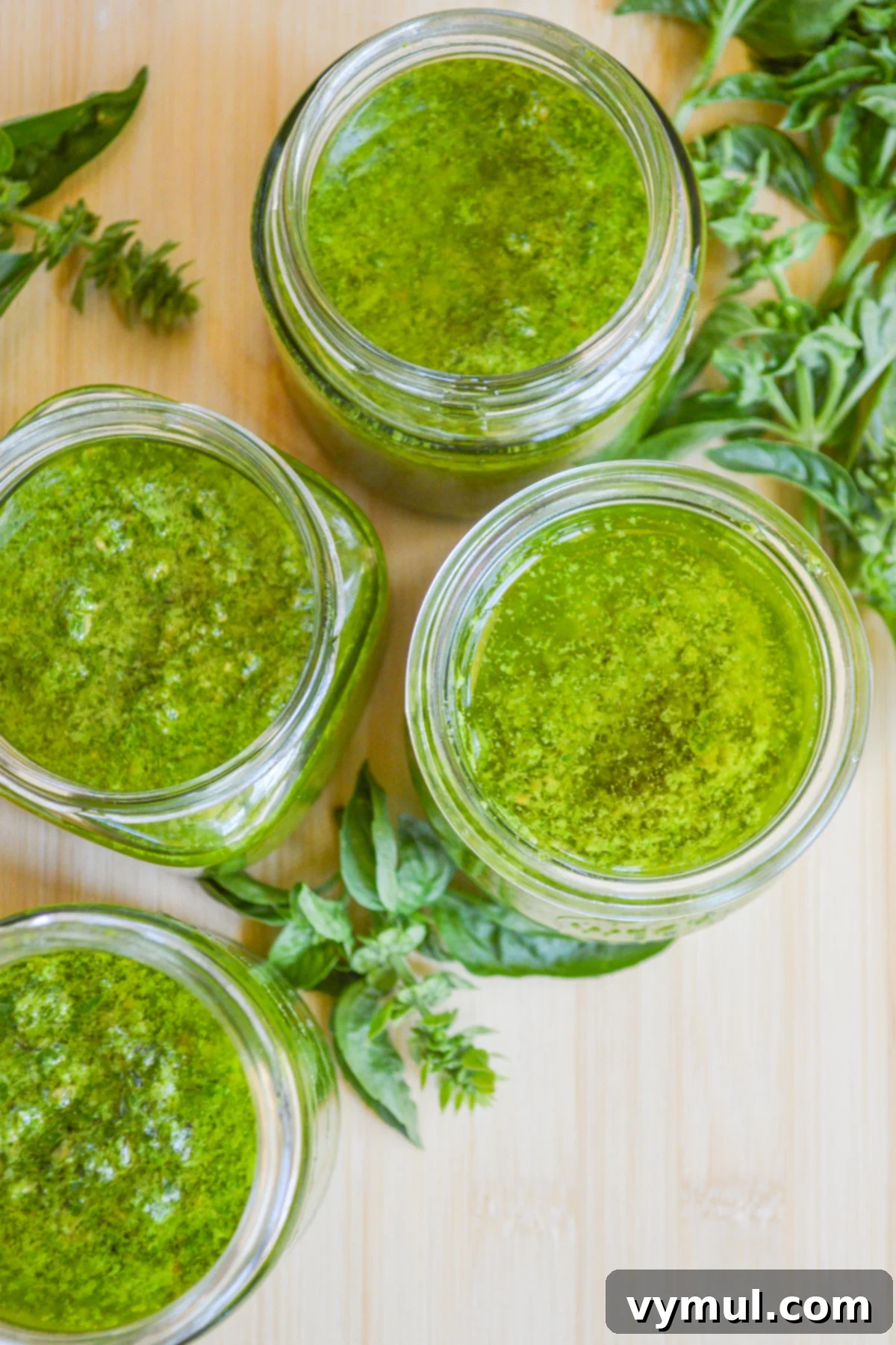 jars of homemade pesto without lids above