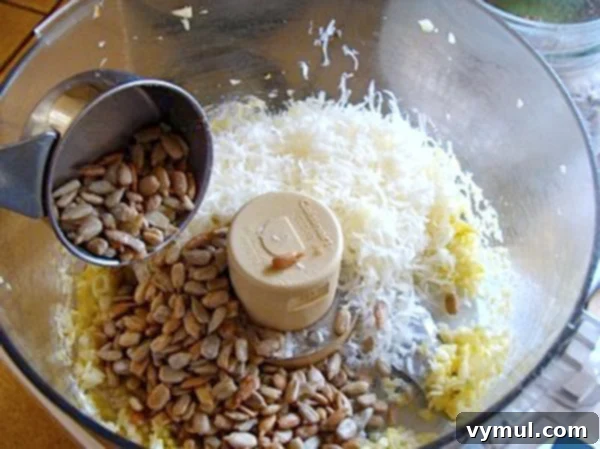 Adding the first pesto ingredients to a food processor