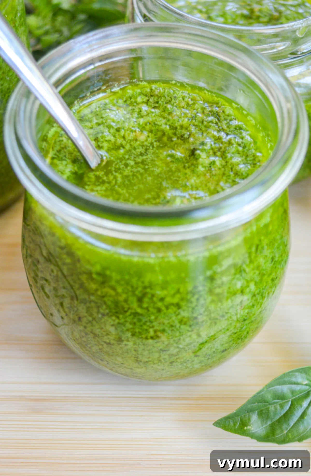 a small jar of pesto with spoon