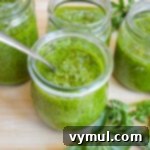 jars of homemade pesto on wood board