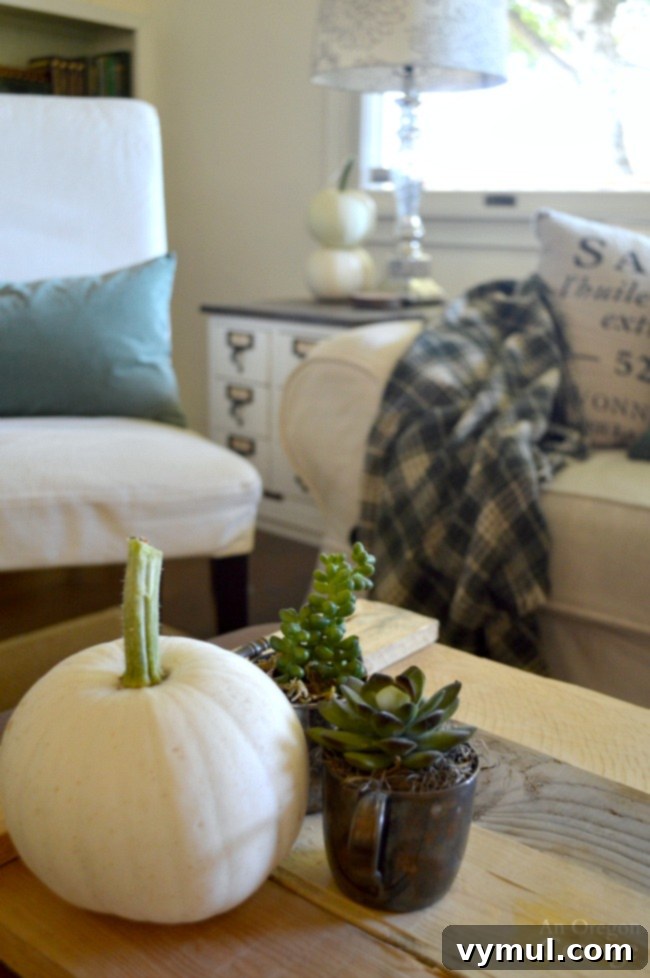 Autumnal Simplicity in Green and White 2 Simple Fall Decor featuring elegant white pumpkins paired with lush green sedum for a natural, understated autumn aesthetic.