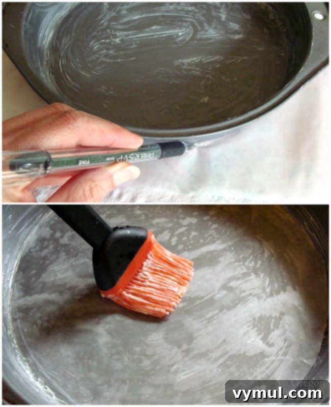 Preparing baking pans by buttering and lining with wax paper for a peanut butter-chocolate celebration cake.