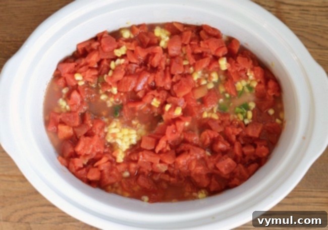 Ultimate Chicken Chili Slow Cooker and Stovetop Recipe 4 Slow Cooker Chicken Chili ingredients prepped and ready to be cooked in the crockpot, showcasing fresh vegetables and chicken.