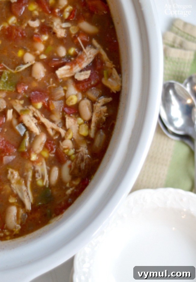Ultimate Chicken Chili Slow Cooker and Stovetop Recipe 6 Slow Cooker Chicken Chili simmering in a crockpot, showcasing a rich, thick texture, ready for the final touches.