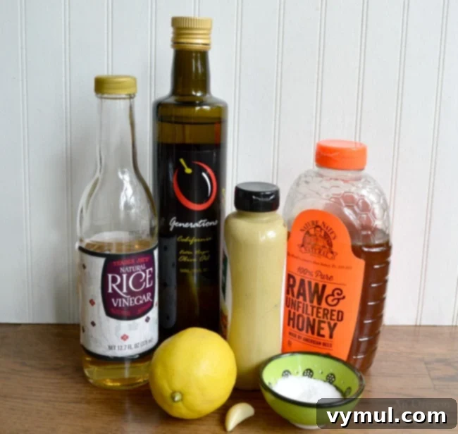 Ultimate Honey Mustard Dressing 4 Six simple ingredients laid out for making Honey Mustard Dressing: honey, olive oil, rice vinegar, Dijon mustard, lemon, and garlic