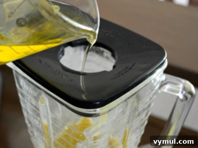 Ultimate Honey Mustard Dressing 5 A blender jar filled with ingredients for Honey Mustard Dressing before olive oil is added, showing the initial mixture