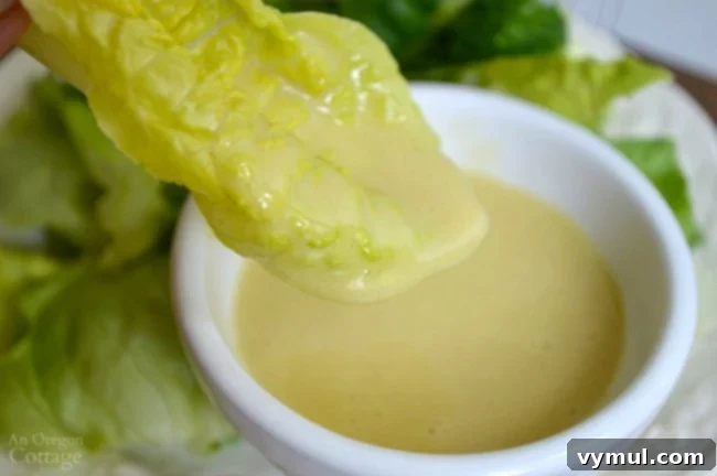 Ultimate Honey Mustard Dressing 6 Freshly made Homemade Honey Mustard Dressing drizzled generously over a bed of crisp lettuce leaves, ready to be enjoyed