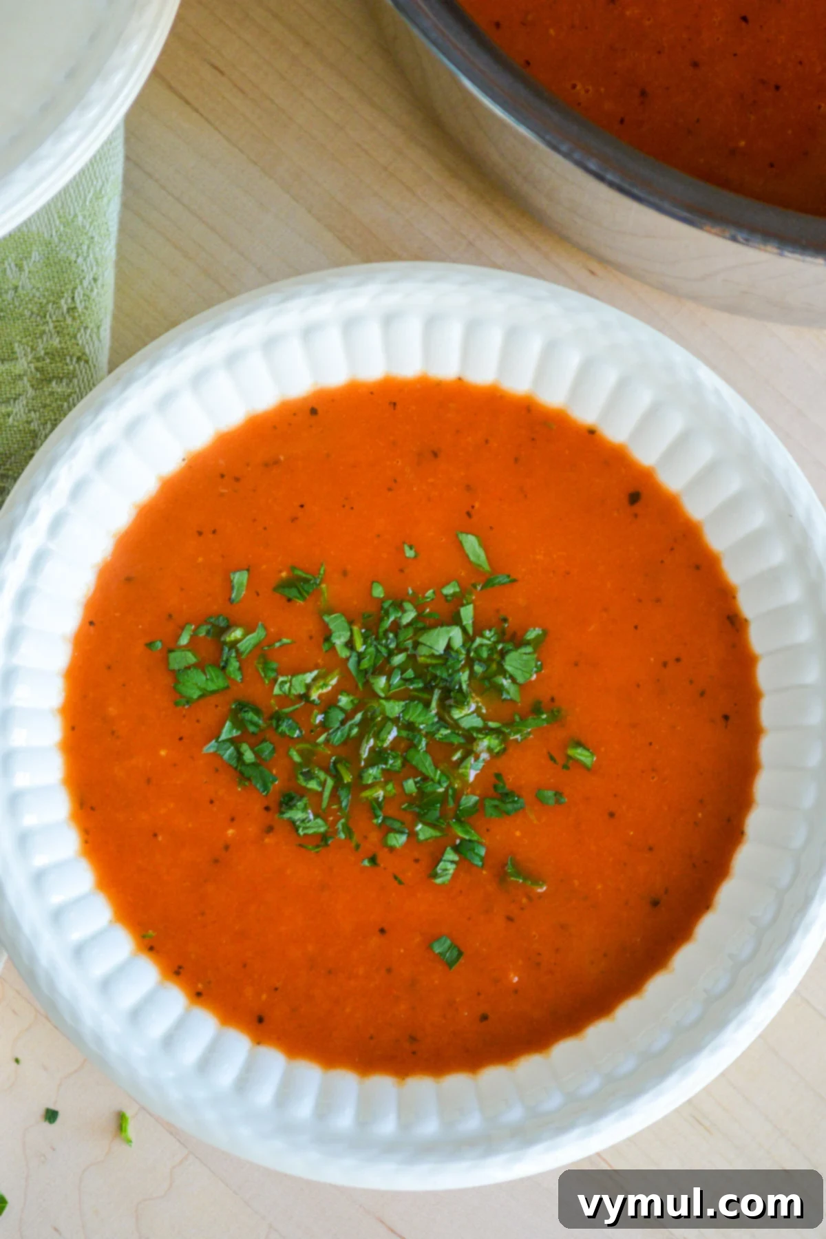 Homemade Tomato Soup Perfection: Say Goodbye To Canned Forever 2 A steaming bowl of homemade tomato soup, garnished with fresh basil, ready to be enjoyed.
