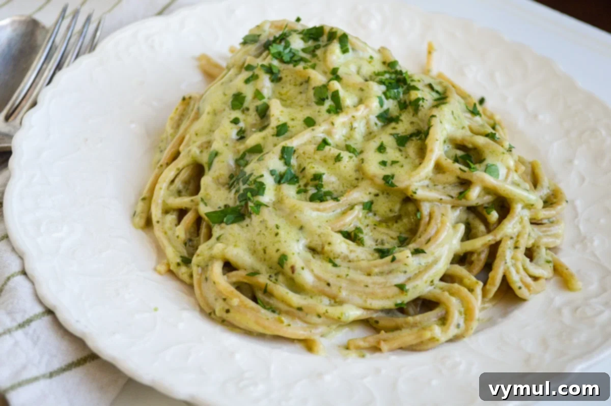 creamy pesto pasta on white plate