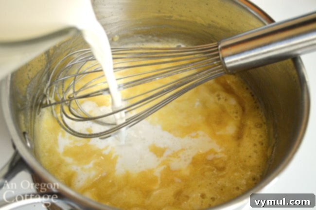 Pouring milk into Creamy Pesto Pasta sauce