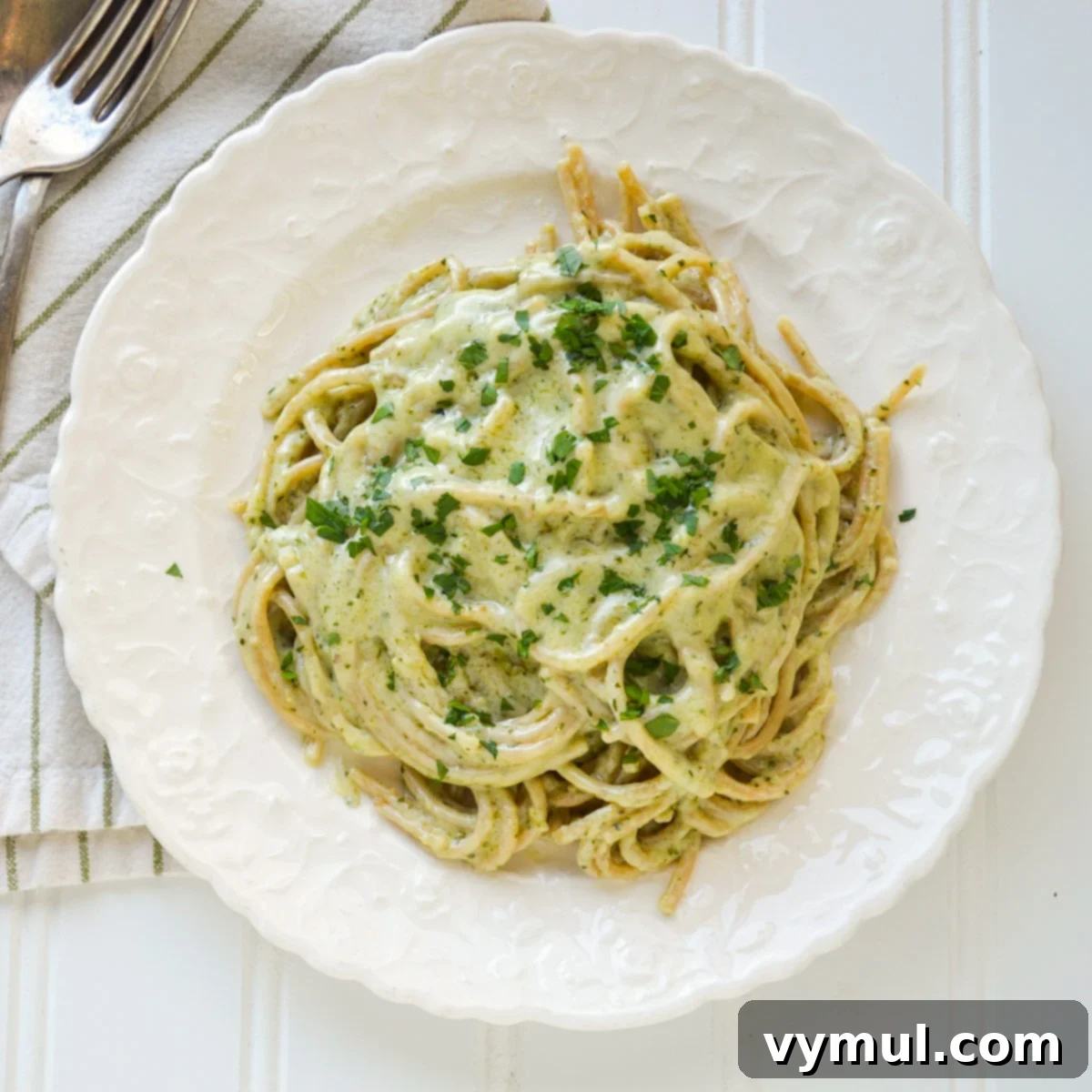 creamy pesto pasta on white plate from above