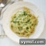 creamy pesto pasta on white plate from above