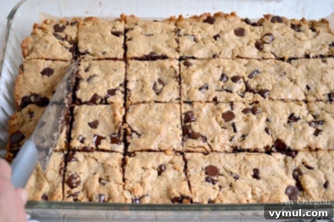 Cutting freshly baked Whole Grain Chocolate Chip Peanut Butter Bars